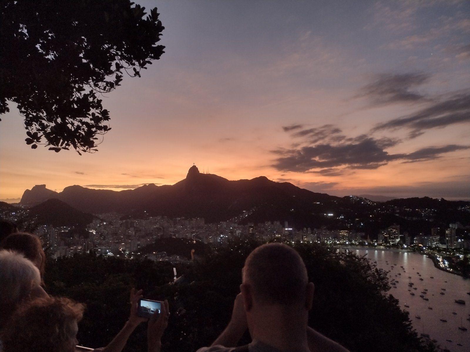 Travellers photographing a Rio sunset with Corcovado in silhouette