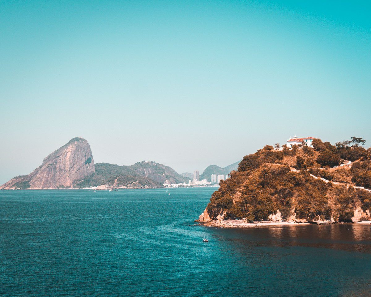 Rock formations and open water along the shoreline of Guanabara Bay in Rio de Janeiro